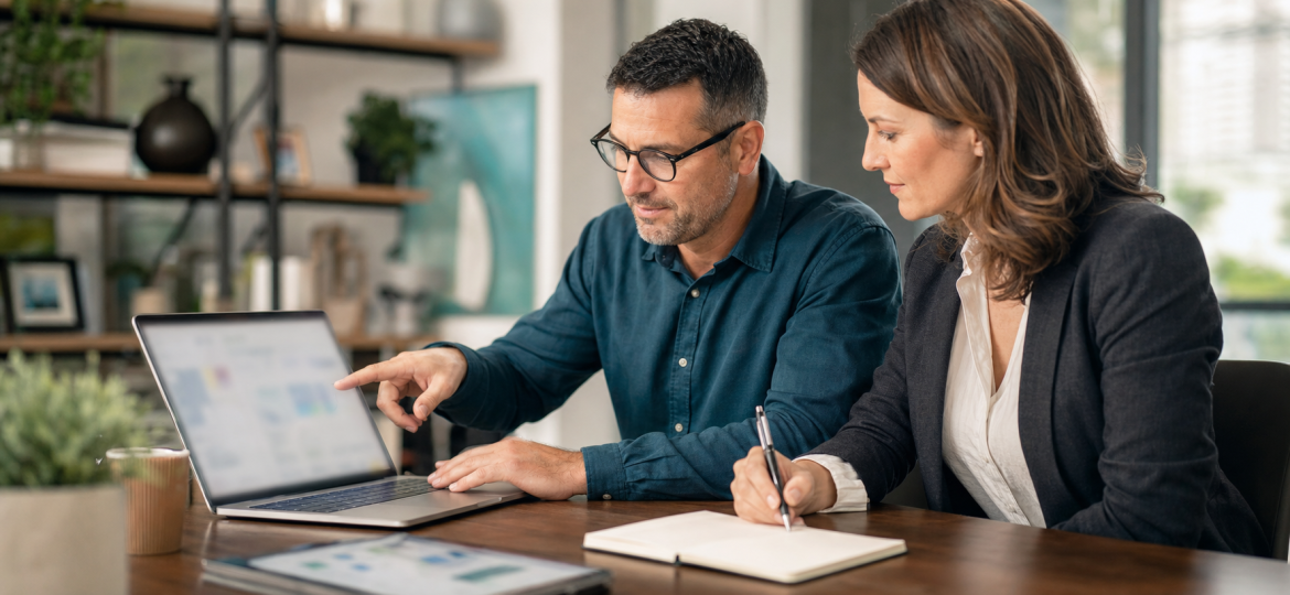 Small business owner and sales manager reviewing blurred lead notes and a sales dashboard before a call
