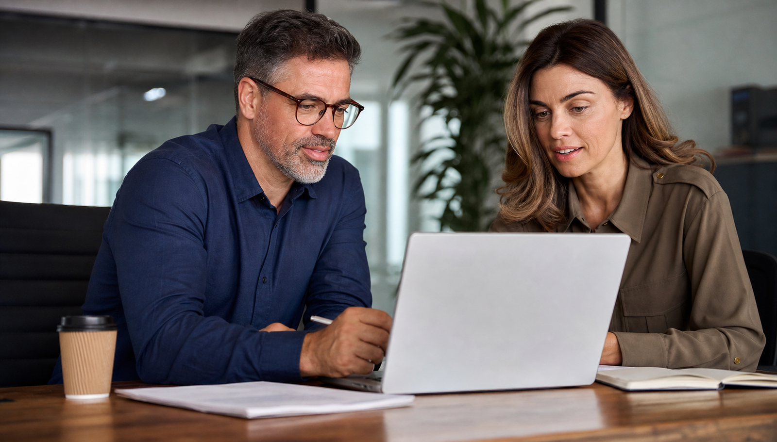 Small business owner and consultant reviewing Google AI Overviews visibility planning