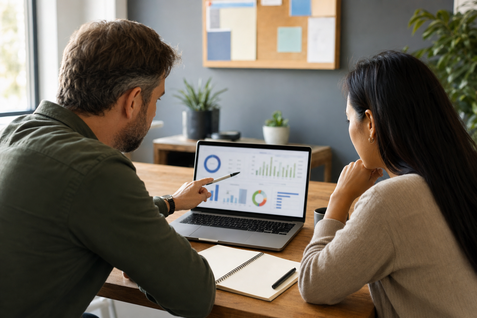 Small business owner and team member reviewing blurred lead follow-up performance charts