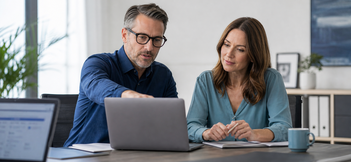 Small business owner and technical advisor reviewing crawler access decisions for AI search visibility