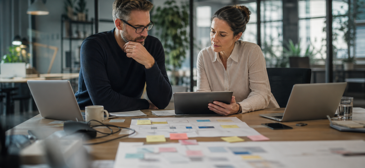Small business owner and operations lead choosing an AI automation stack during a practical workflow planning session