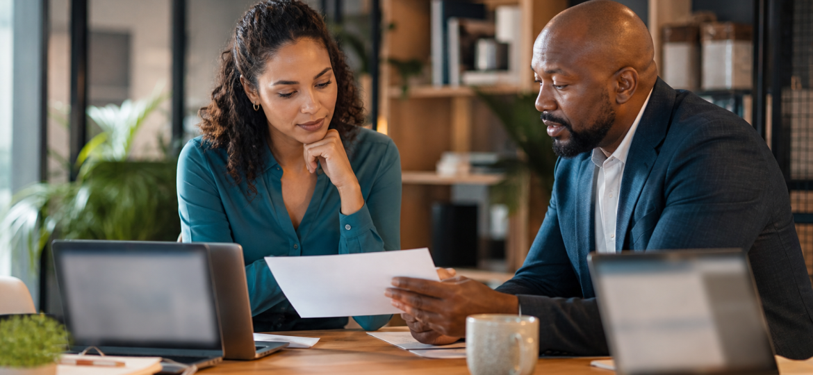 Small business owner and operations lead reviewing simple AI governance rules before scaling automation workflows
