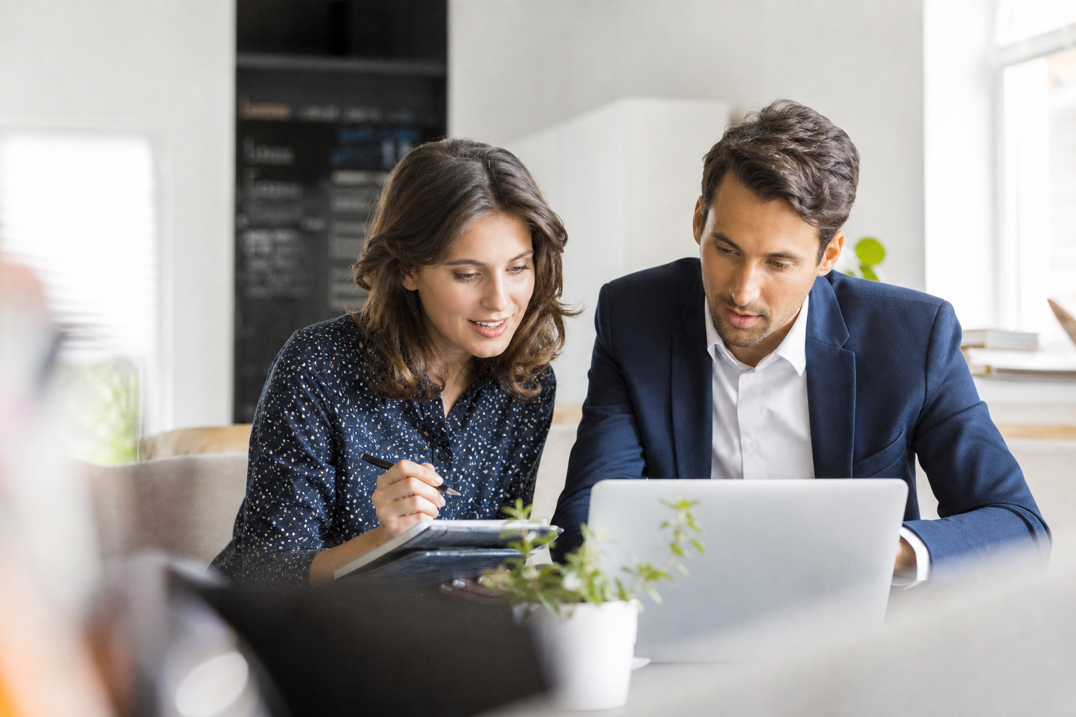Small business owner and consultant reviewing website content for AI search citation readiness