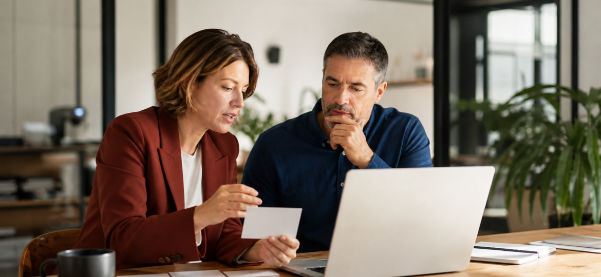Small business owner and advisor reviewing customer questions for an AI-search-ready FAQ page