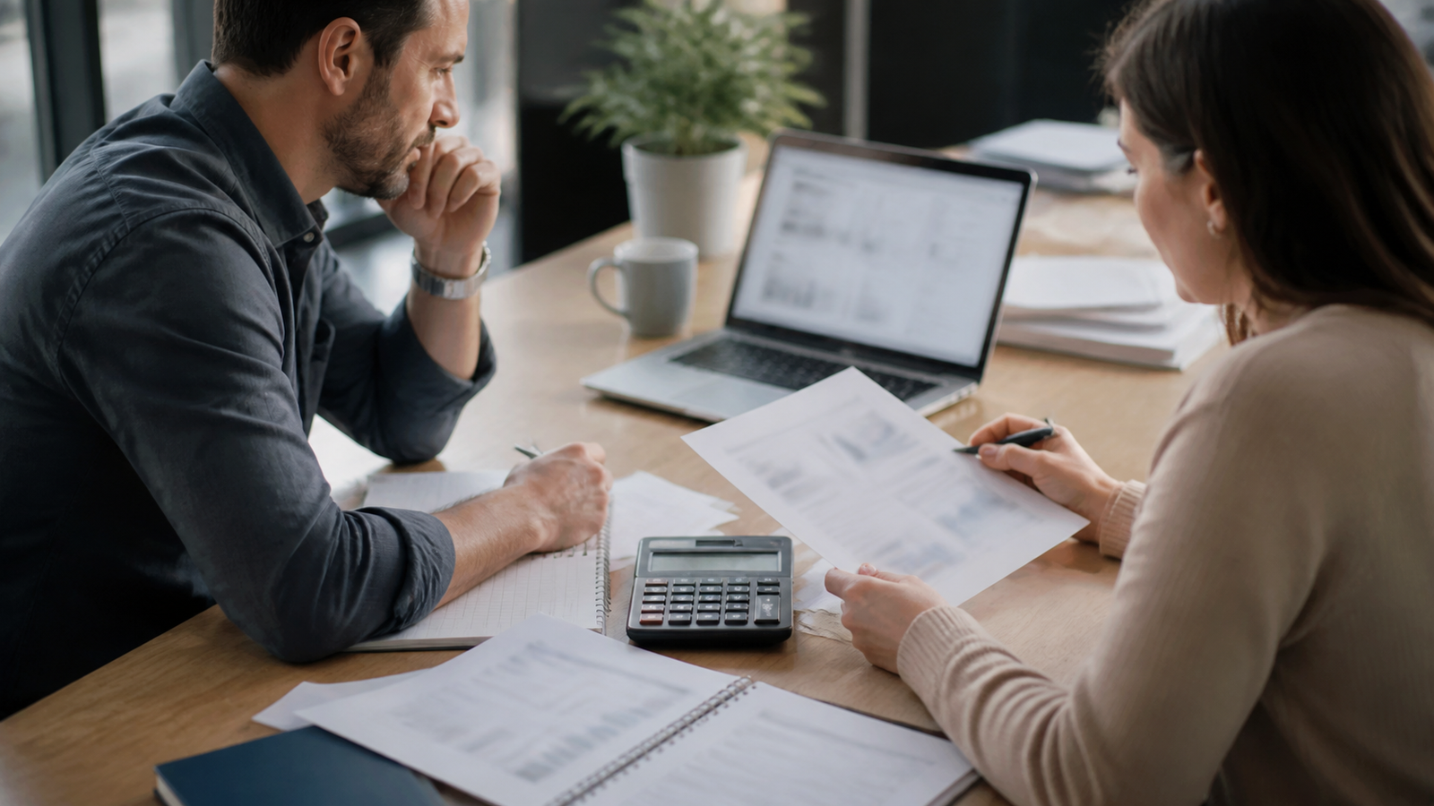 Small business owner and operations lead reviewing GEO budget timing