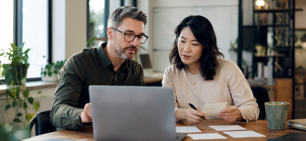 Small business owner and operations lead reviewing AI-assisted workflow outputs before customer use