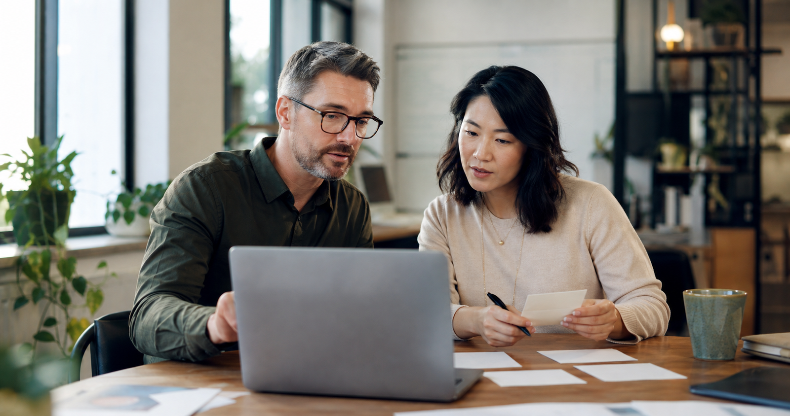 Small business owner and operations lead reviewing AI-assisted workflow outputs before customer use