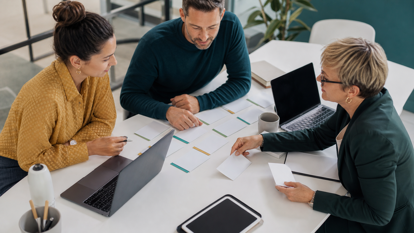 Small business team running an AI visibility prompt test with blank cards and devices