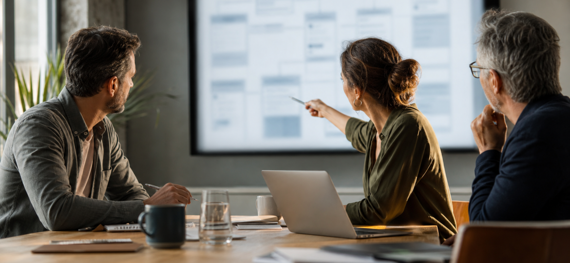 Small business owner and web advisor reviewing schema markup decisions for GEO and AI search visibility
